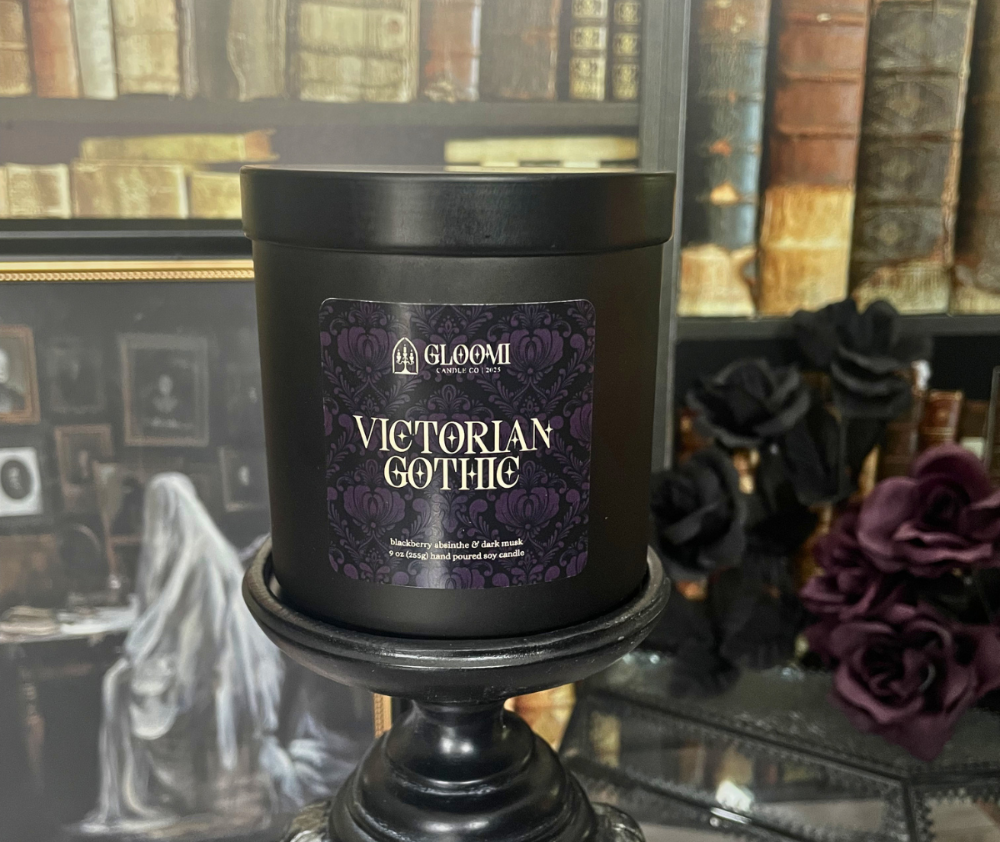 Black candle with 'Victorian Gothic' label in front of a decorative background with books and black roses.